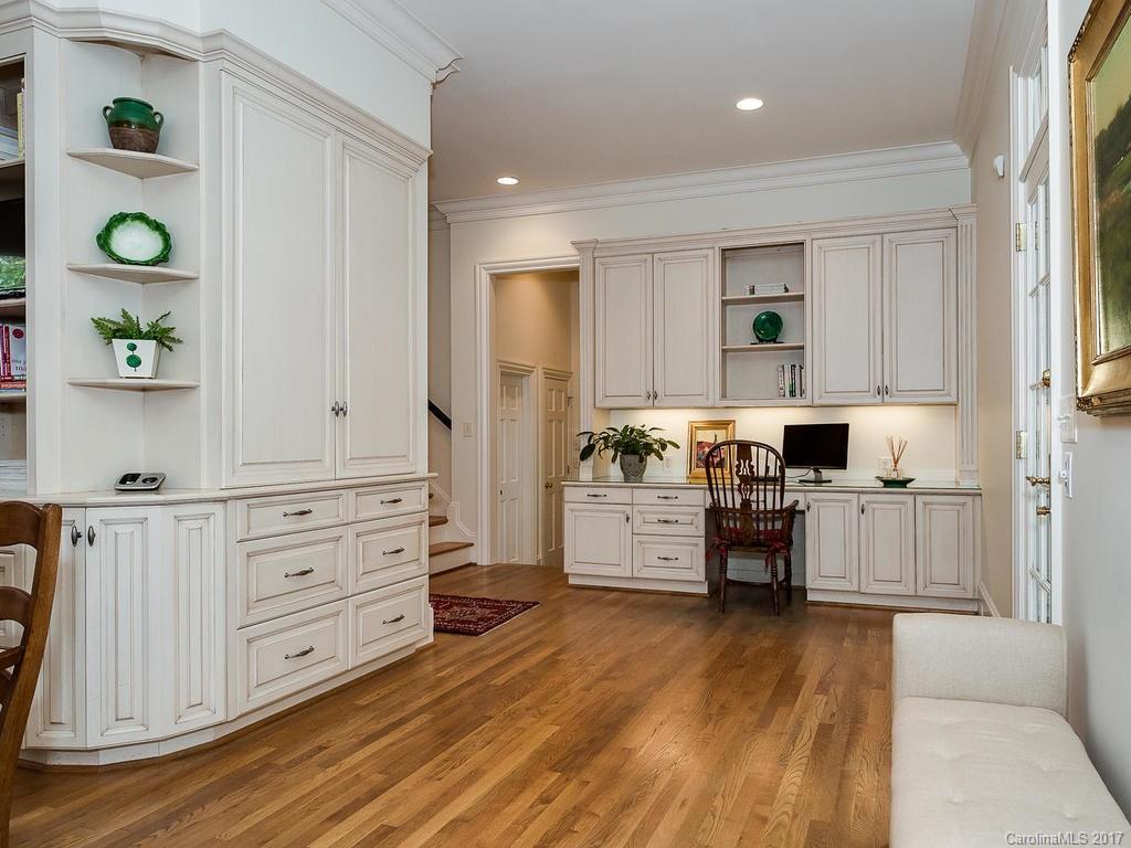 1911 Harris Road Charlotte, NC 28211 - Photo 7 of 24 a kitchen with white cabinets and wooden floor