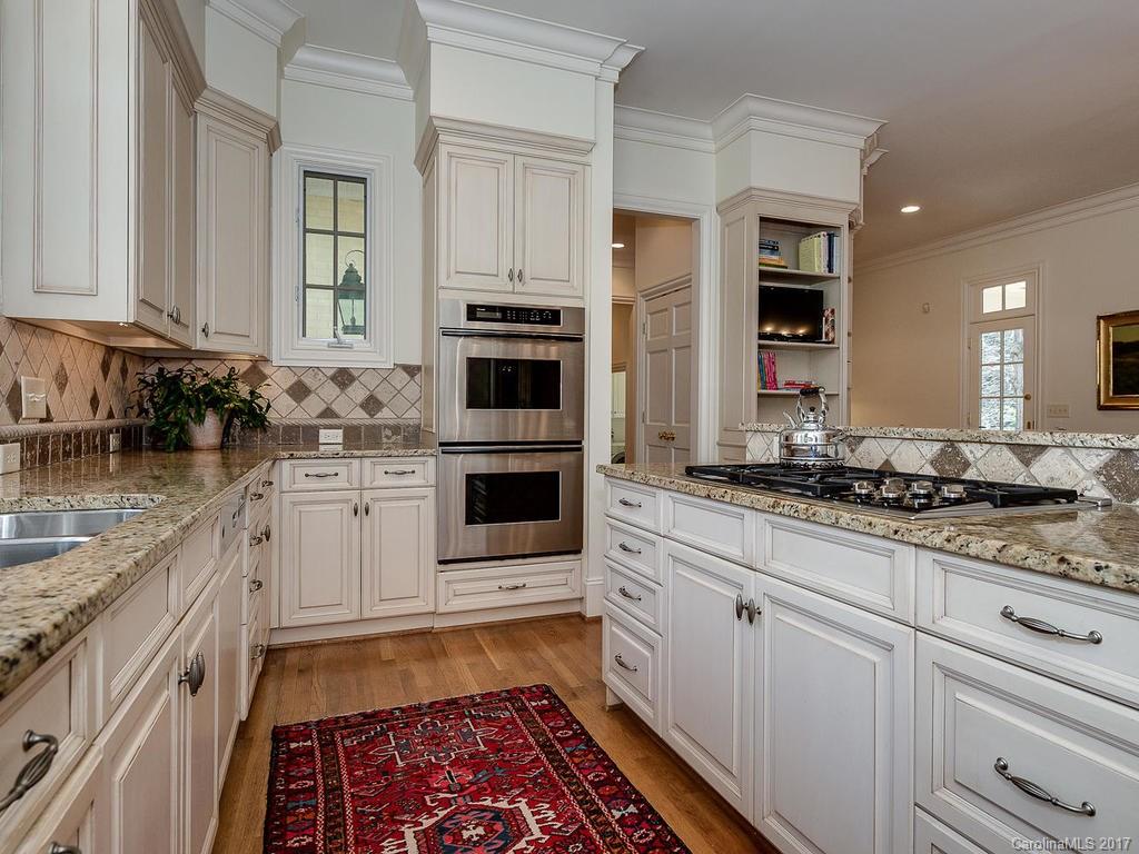1911 Harris Road Charlotte, NC 28211 - Photo 8 of 24 a kitchen with stainless steel appliances granite countertop a stove a sink and a microwave