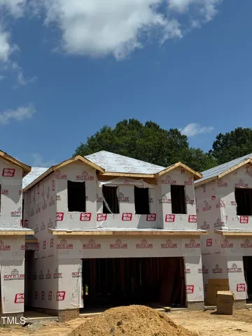 a front view of multiple houses with yard