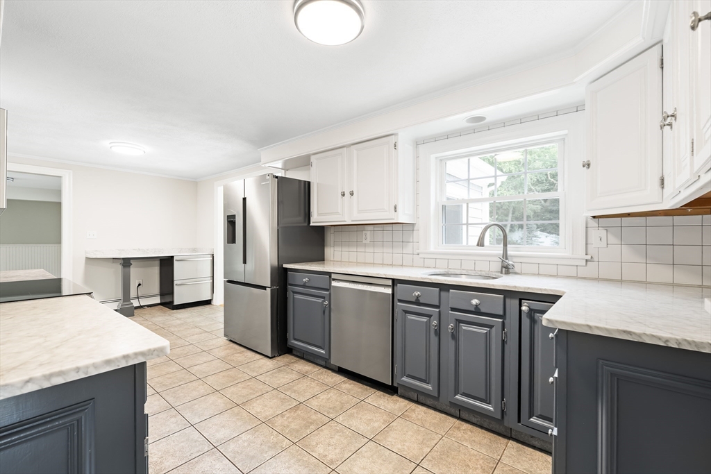 17 Appleton Road Natick, MA 01760 - Photo 11 of 42 a kitchen with granite countertop a sink stainless steel appliances and cabinets