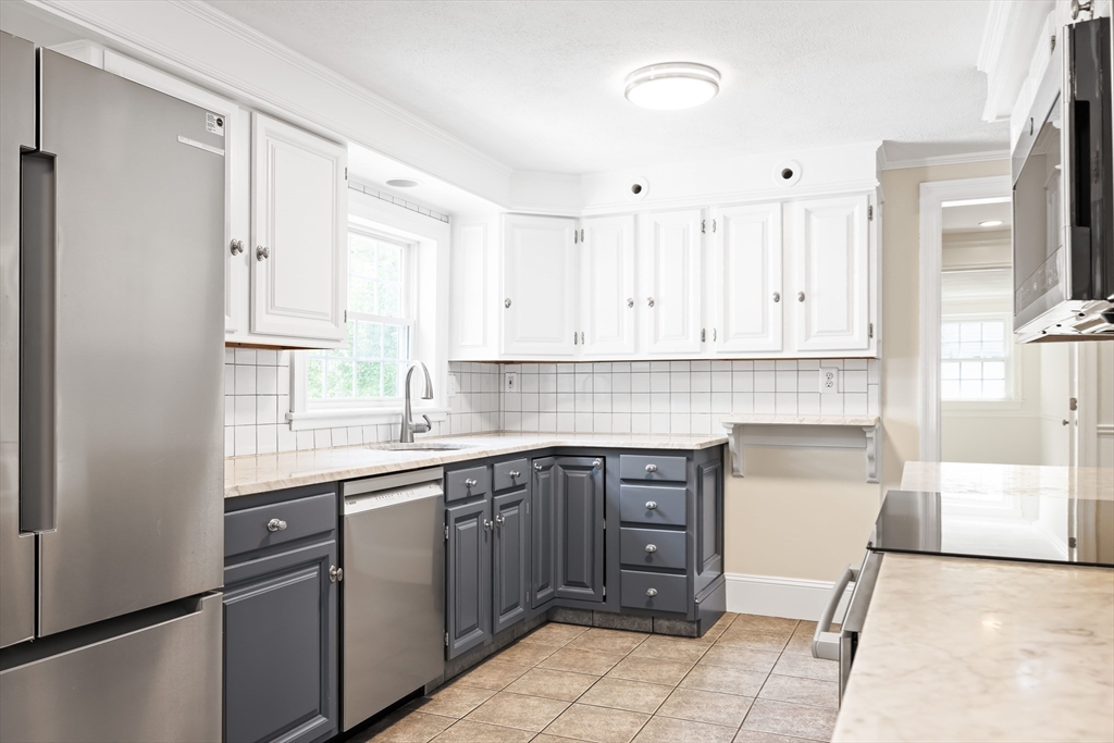 17 Appleton Road Natick, MA 01760 - Photo 12 of 42 a kitchen with a sink stove and cabinets