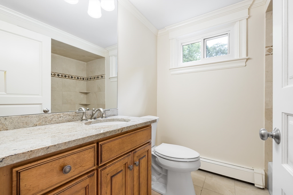 17 Appleton Road Natick, MA 01760 - Photo 20 of 42 a bathroom with a granite countertop toilet sink and mirror