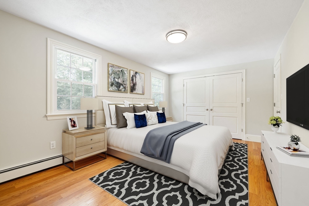 17 Appleton Road Natick, MA 01760 - Photo 26 of 42 a bedroom with a bed and a flat screen tv