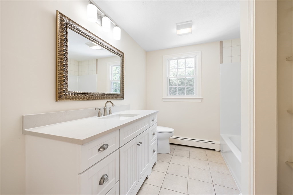 17 Appleton Road Natick, MA 01760 - Photo 28 of 42 a bathroom with a sink a toilet and mirror
