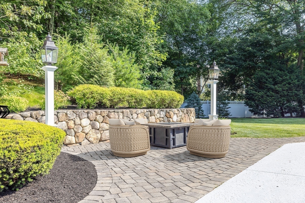17 Appleton Road Natick, MA 01760 - Photo 4 of 42 a view of a patio with table and chairs potted plants and large tree