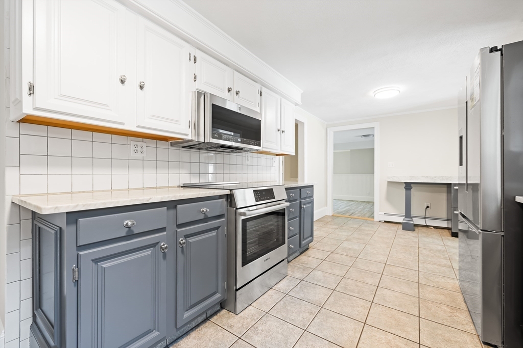 17 Appleton Road Natick, MA 01760 - Photo 10 of 42 a kitchen with stainless steel appliances granite countertop a sink and a stove