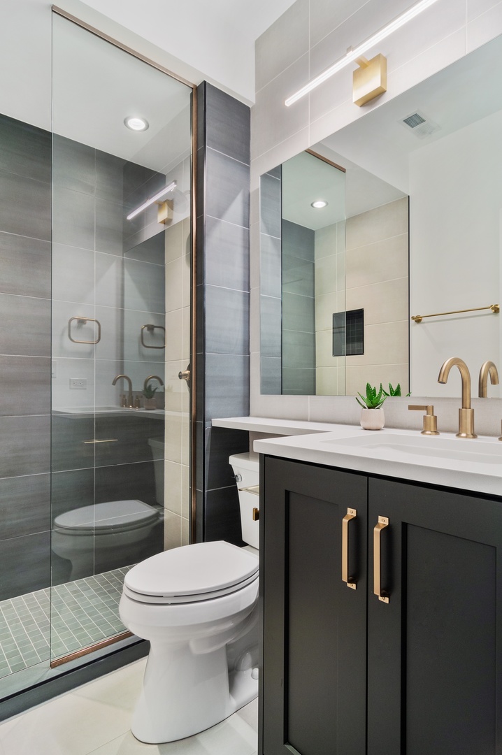 1116 West Addison Street, Unit 2 Chicago, IL 60613 - Photo 13 of 16 a bathroom with a sink a toilet and shower