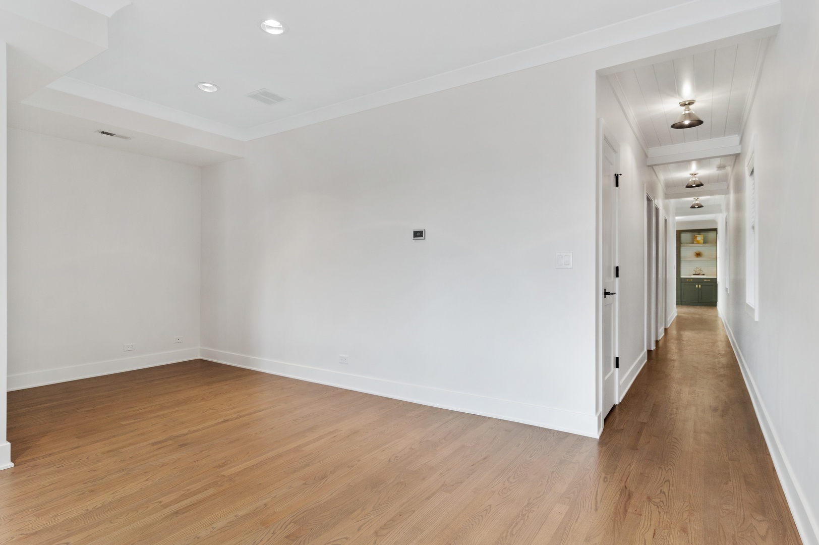 1116 West Addison Street, Unit 2 Chicago, IL 60613 - Photo 4 of 16 wooden floor in an empty room with a gallery
