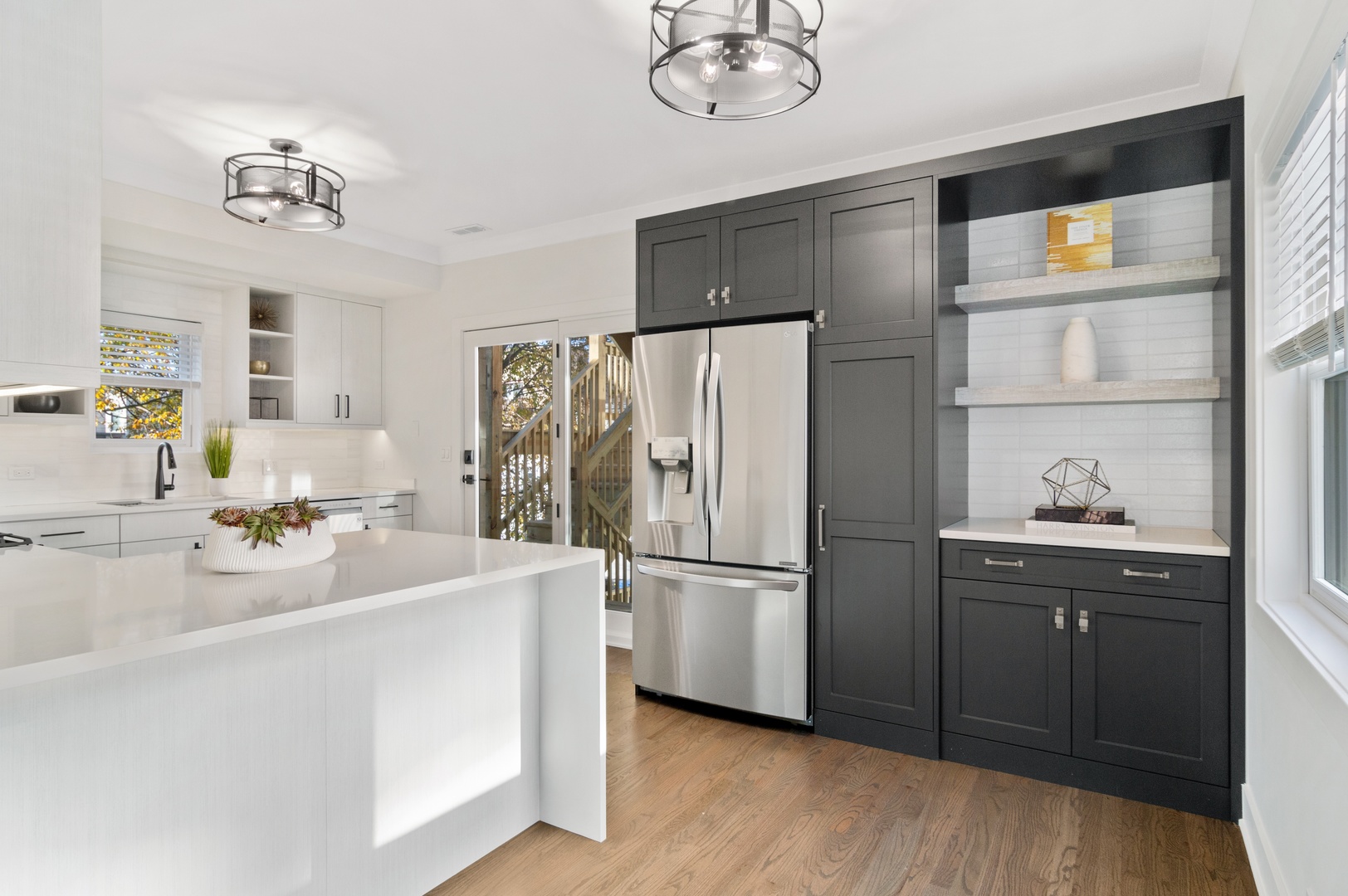 1116 West Addison Street, Unit 2 Chicago, IL 60613 - Photo 6 of 16 a kitchen with refrigerator cabinets and wooden floor