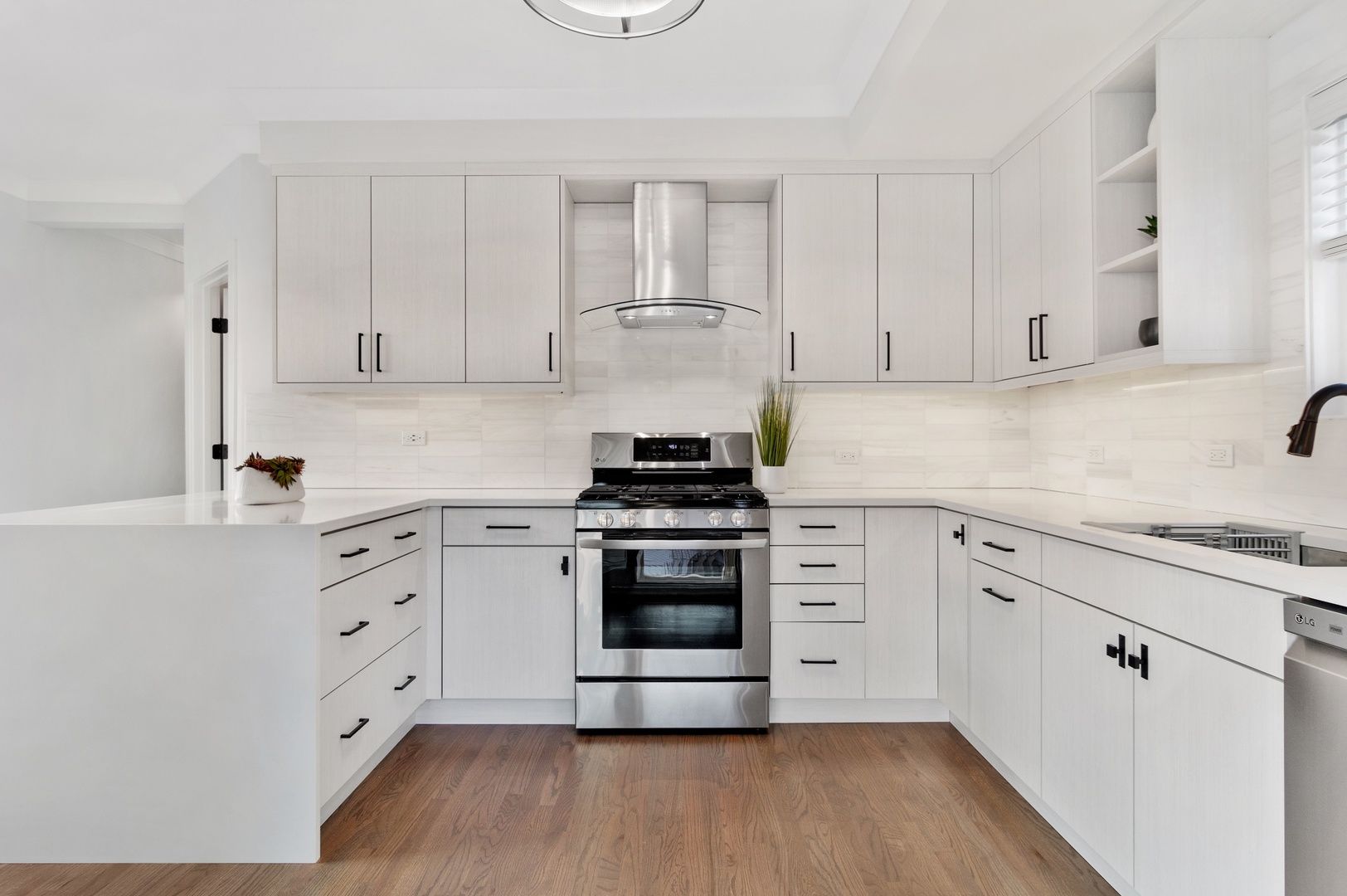 1116 West Addison Street, Unit 2 Chicago, IL 60613 - Photo 9 of 16 a kitchen with white cabinets and stainless steel appliances