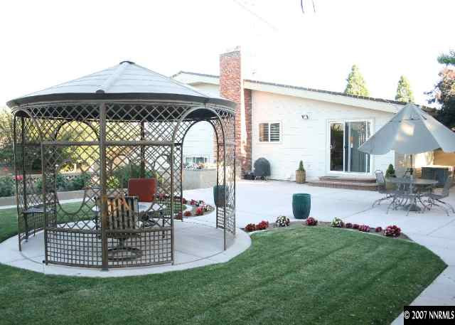 1025 West 12th Street Reno, NV 89503 - Photo 8 of 9 a view of a chair and table in the back yard of the house