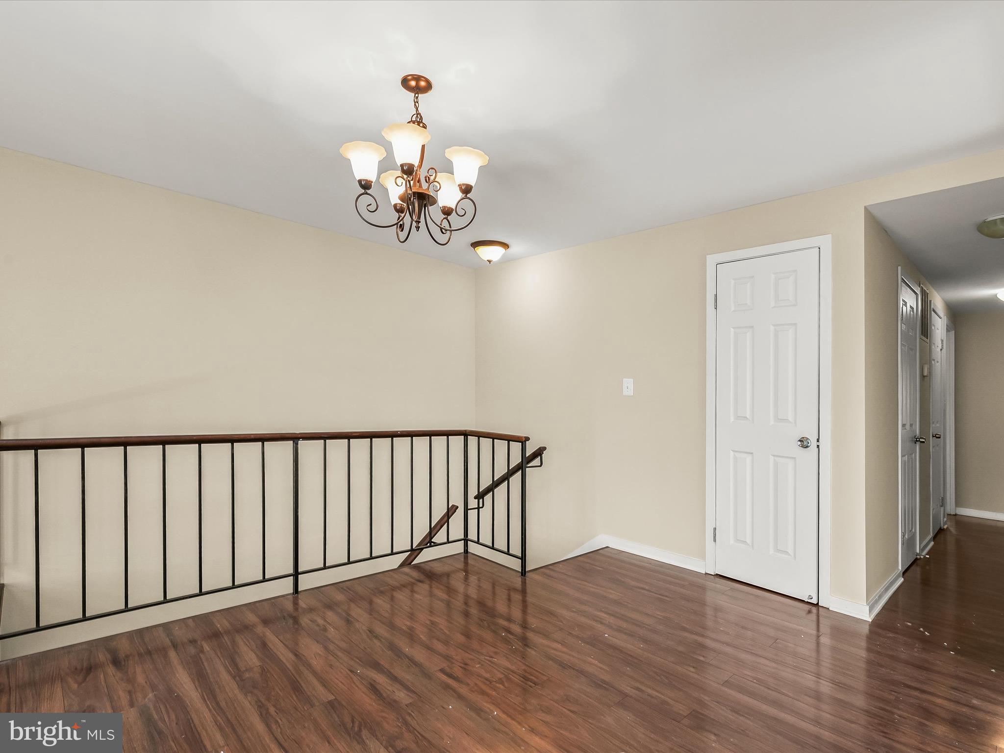 407 South Sharp Street, Unit R 6 Baltimore, MD 21201 - Photo 3 of 20 a view of a chandelier with wooden floor