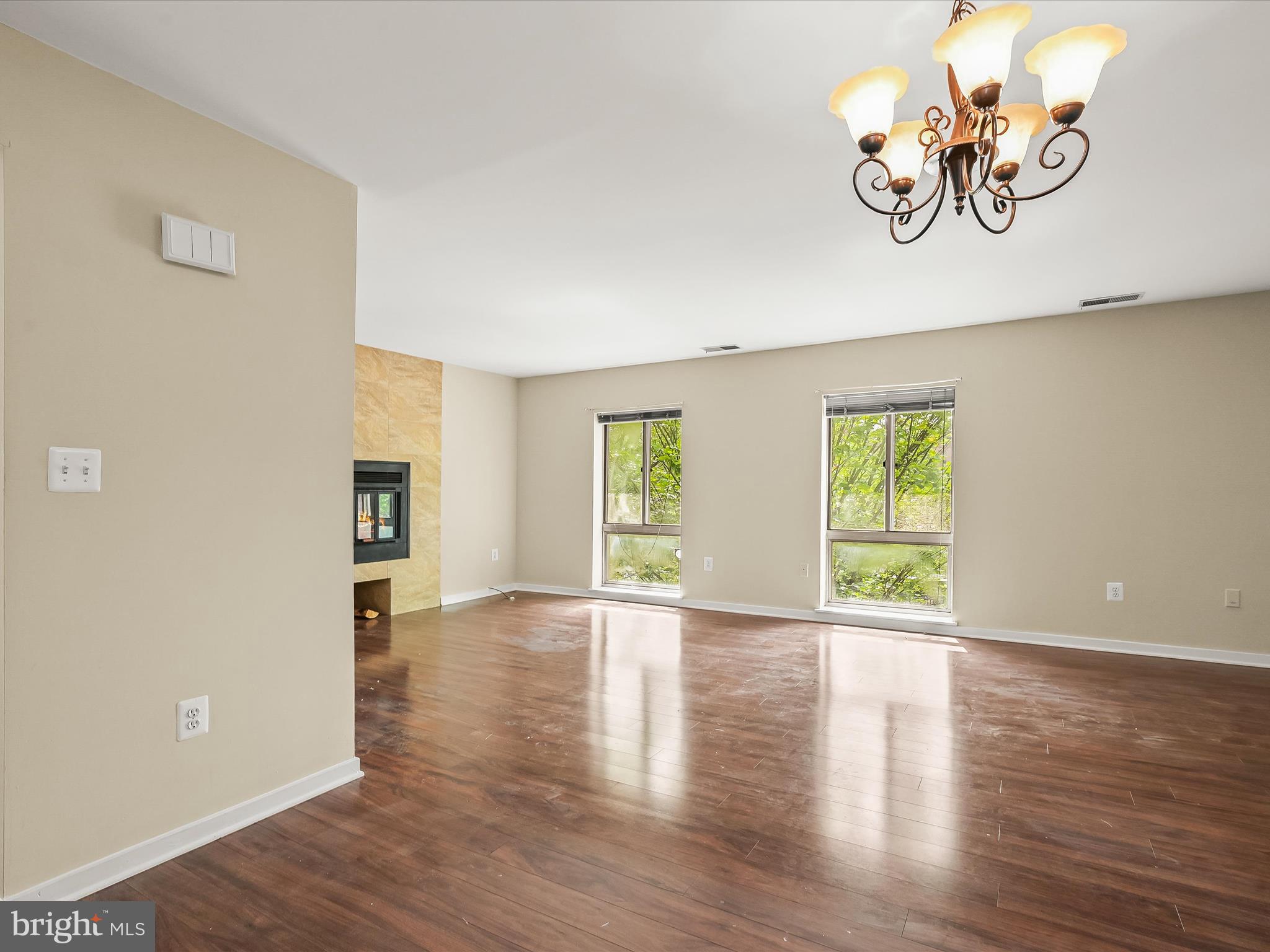 407 South Sharp Street, Unit R 6 Baltimore, MD 21201 - Photo 8 of 20 a view of an empty room with window and wooden floor