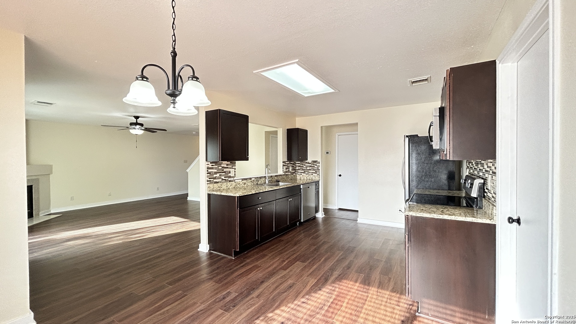 8018 Chestnut Gate Lane Converse, TX 78109 - Photo 11 of 38 a kitchen with stainless steel appliances granite countertop a sink a stove and refrigerator