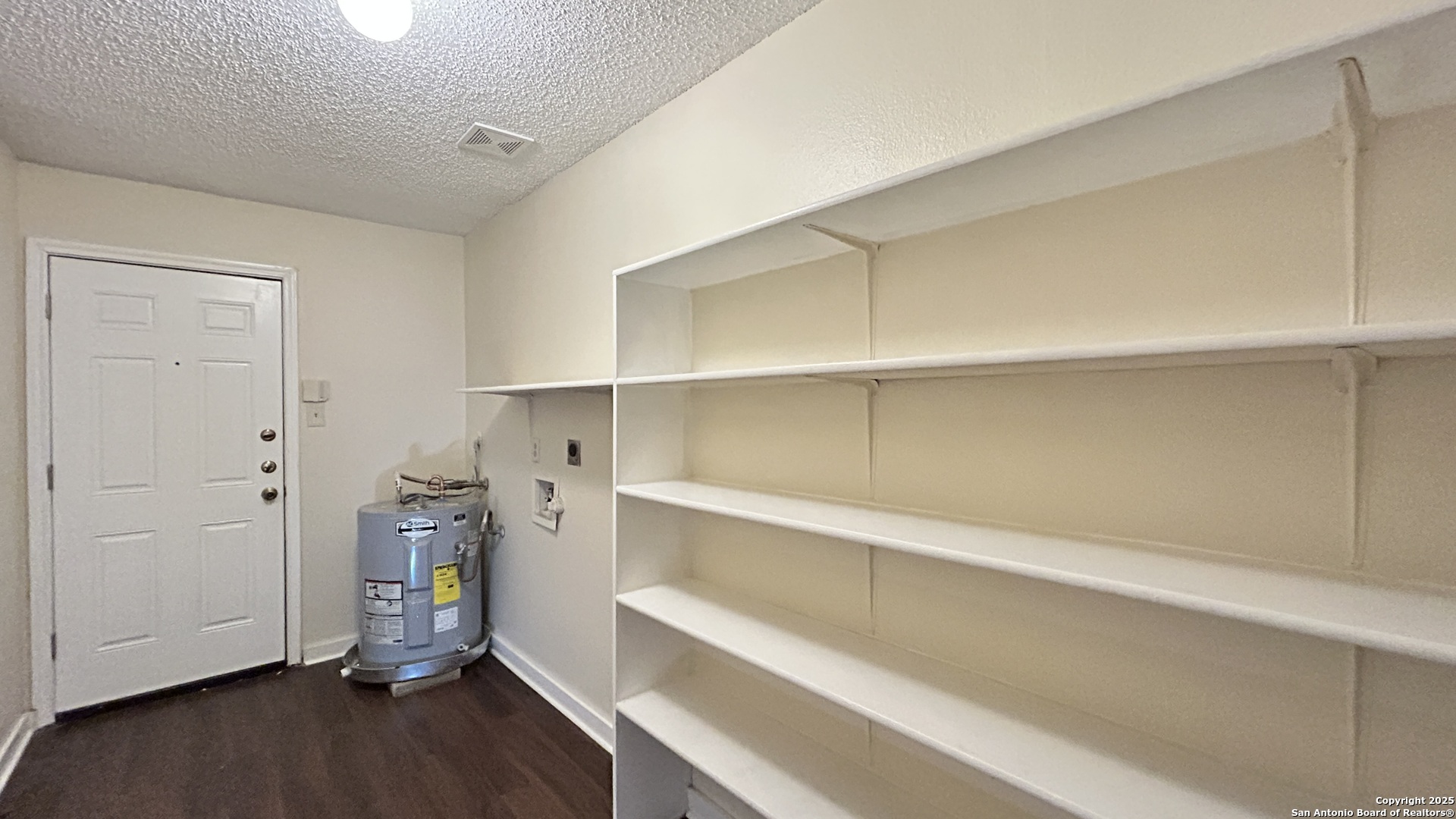8018 Chestnut Gate Lane Converse, TX 78109 - Photo 15 of 38 a view of walk in closet with empty racks