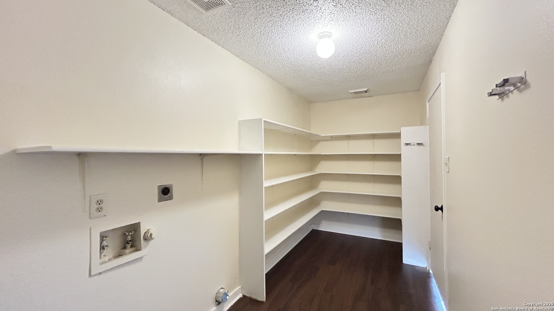 8018 Chestnut Gate Lane Converse, TX 78109 - Photo 16 of 38 a view of walk in closet with empty racks
