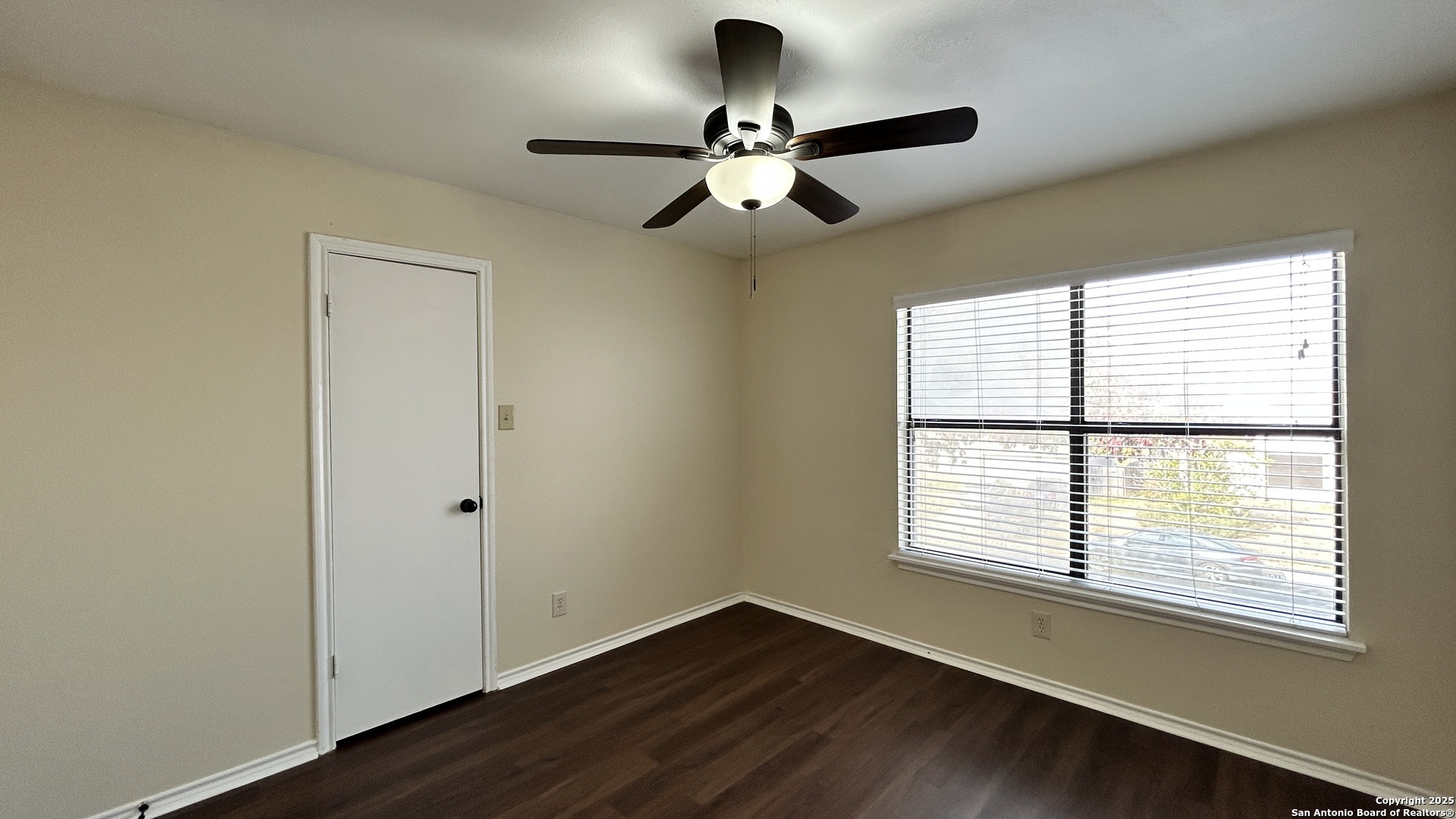8018 Chestnut Gate Lane Converse, TX 78109 - Photo 20 of 38 a view of an empty room with wooden floor and a window