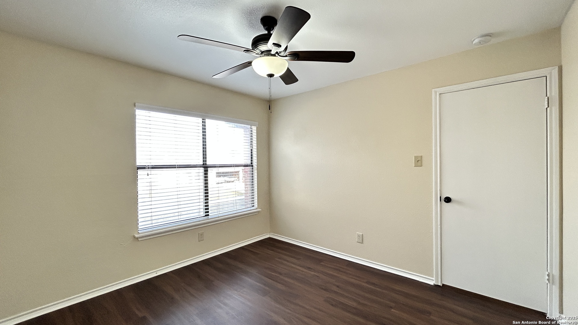 8018 Chestnut Gate Lane Converse, TX 78109 - Photo 21 of 38 an empty room with wooden floor fan and windows