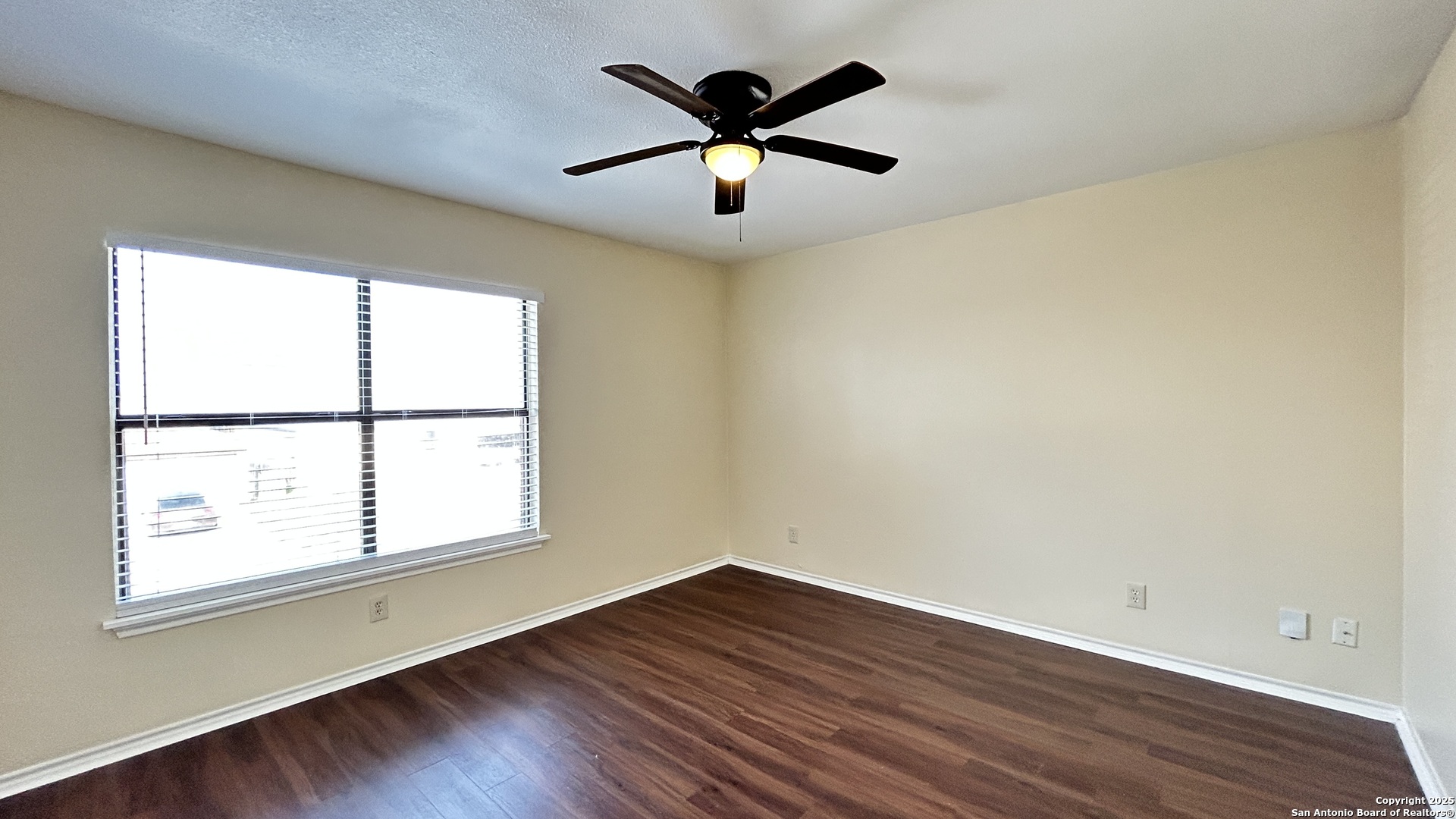 8018 Chestnut Gate Lane Converse, TX 78109 - Photo 24 of 38 an empty room with wooden floor and windows