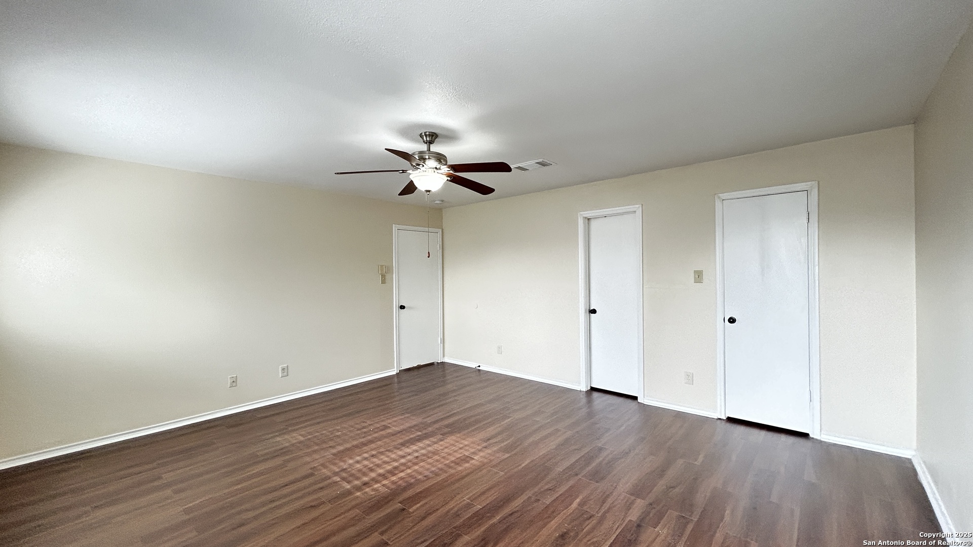 8018 Chestnut Gate Lane Converse, TX 78109 - Photo 29 of 38 a view of a room with wooden floor and ceiling fan