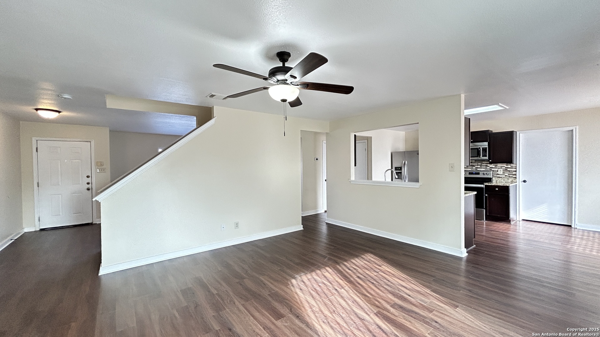 8018 Chestnut Gate Lane Converse, TX 78109 - Photo 6 of 38 a view of a big room with wooden floor and a ceiling fan