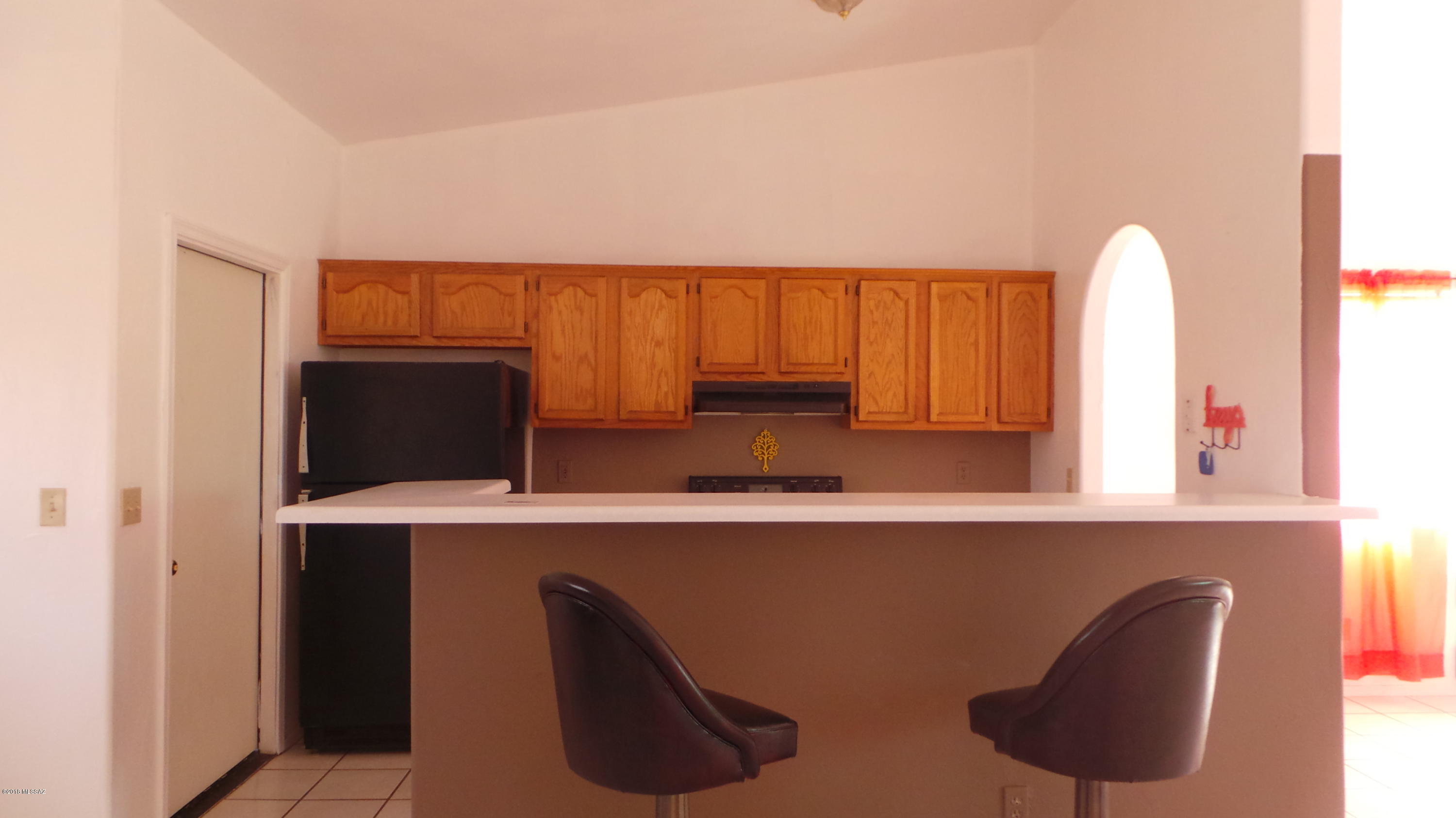 294 Placita Managua Rio Rico, AZ 85648 - Photo 10 of 33 a view of cabinets with chair and wooden floor