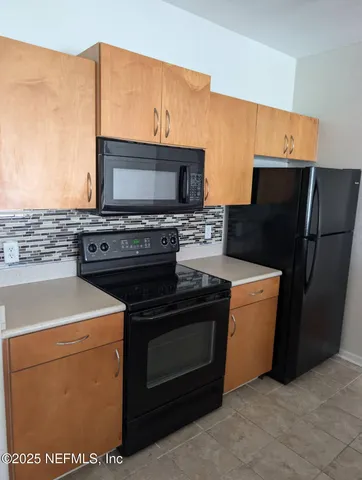 a kitchen with a stove and a microwave