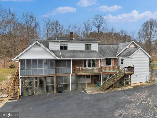 a view of a house with a yard and wooden fence