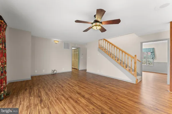 a view of a house with a yard covered with snow in the background