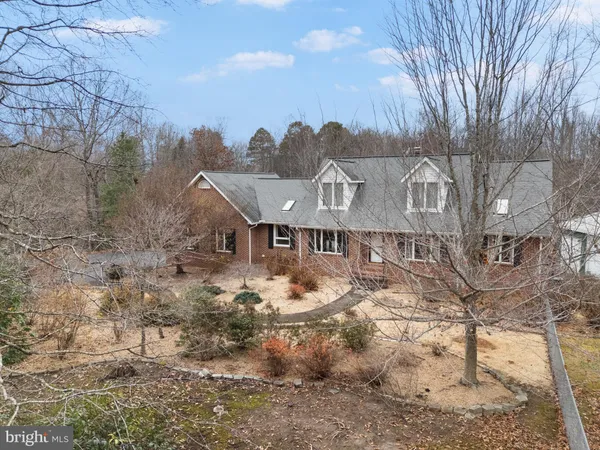 a view of a house with a deck and a yard