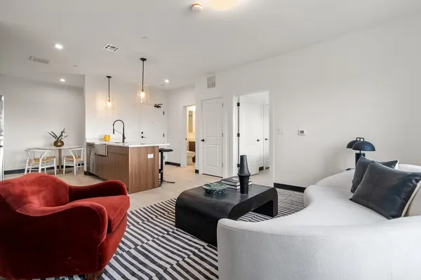 a living room with furniture a couch and wooden floor