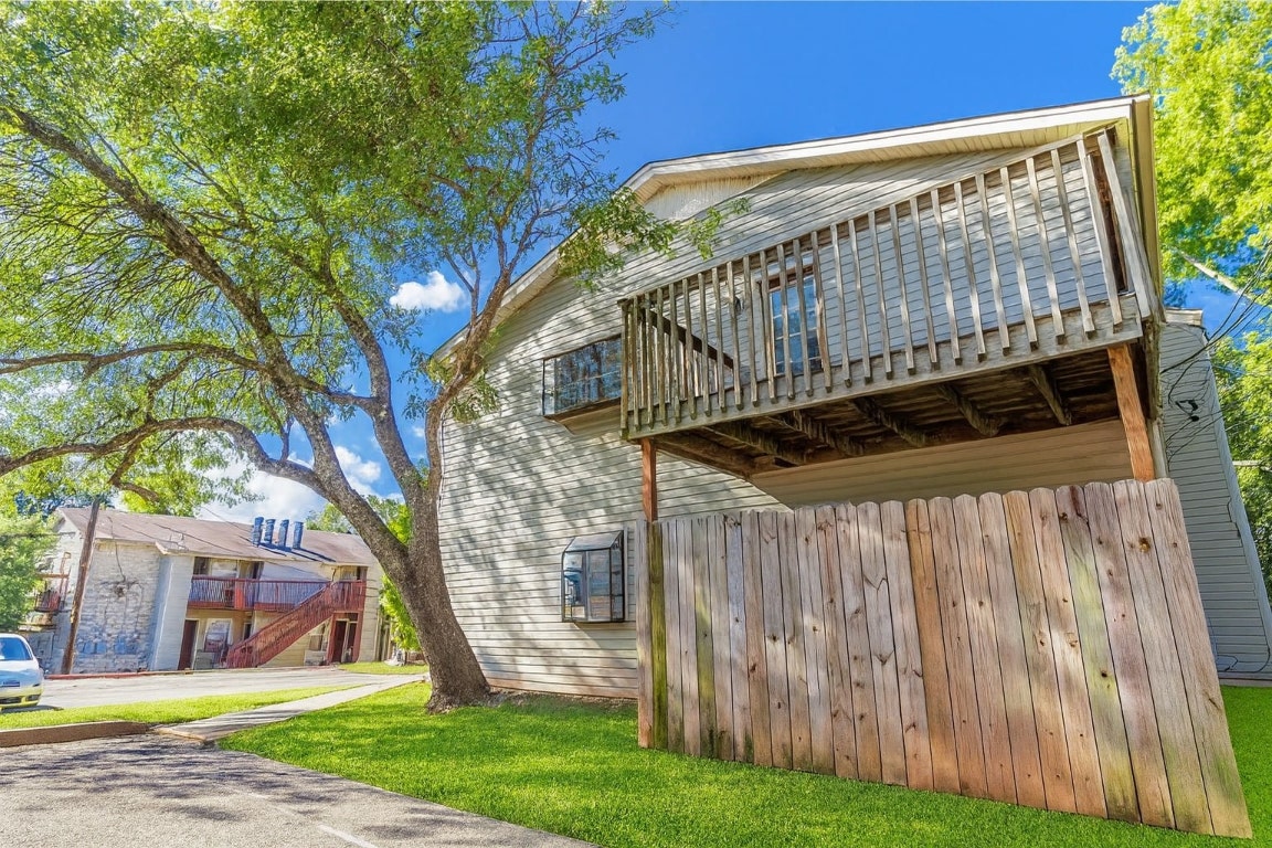 903 Taulbee Lane, Unit D Austin, TX 78757 - Photo 11 of 13 a view of a wooden deck with a yard