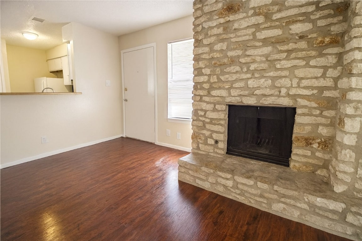 903 Taulbee Lane, Unit D Austin, TX 78757 - Photo 2 of 13 a living room with a fireplace