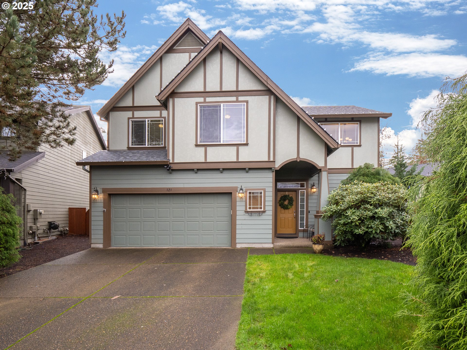a front view of a house with a yard and garage