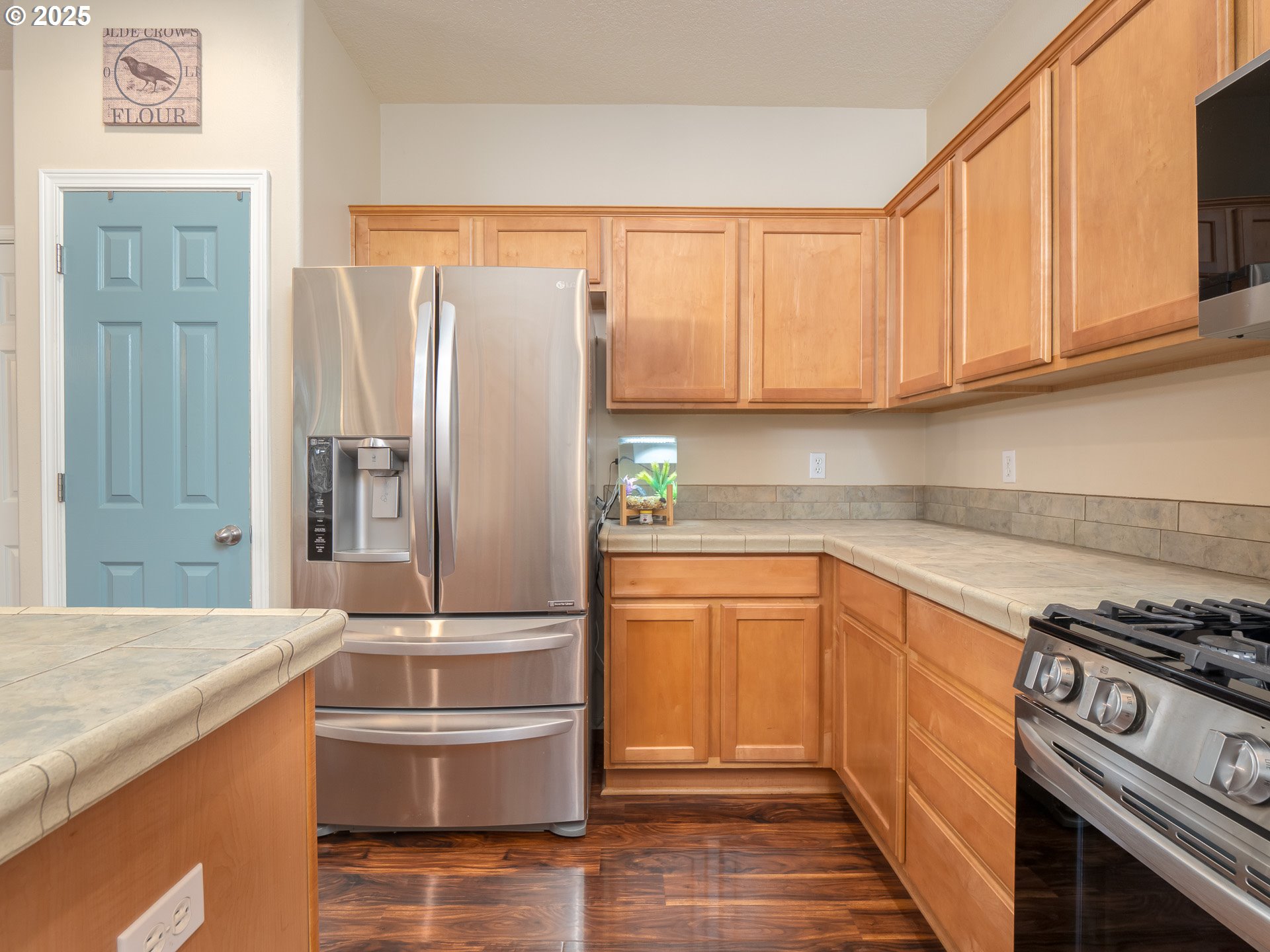 121 Burl Street Newberg, OR 97132 - Photo 13 of 48 a kitchen with stainless steel appliances granite countertop a sink stove and refrigerator