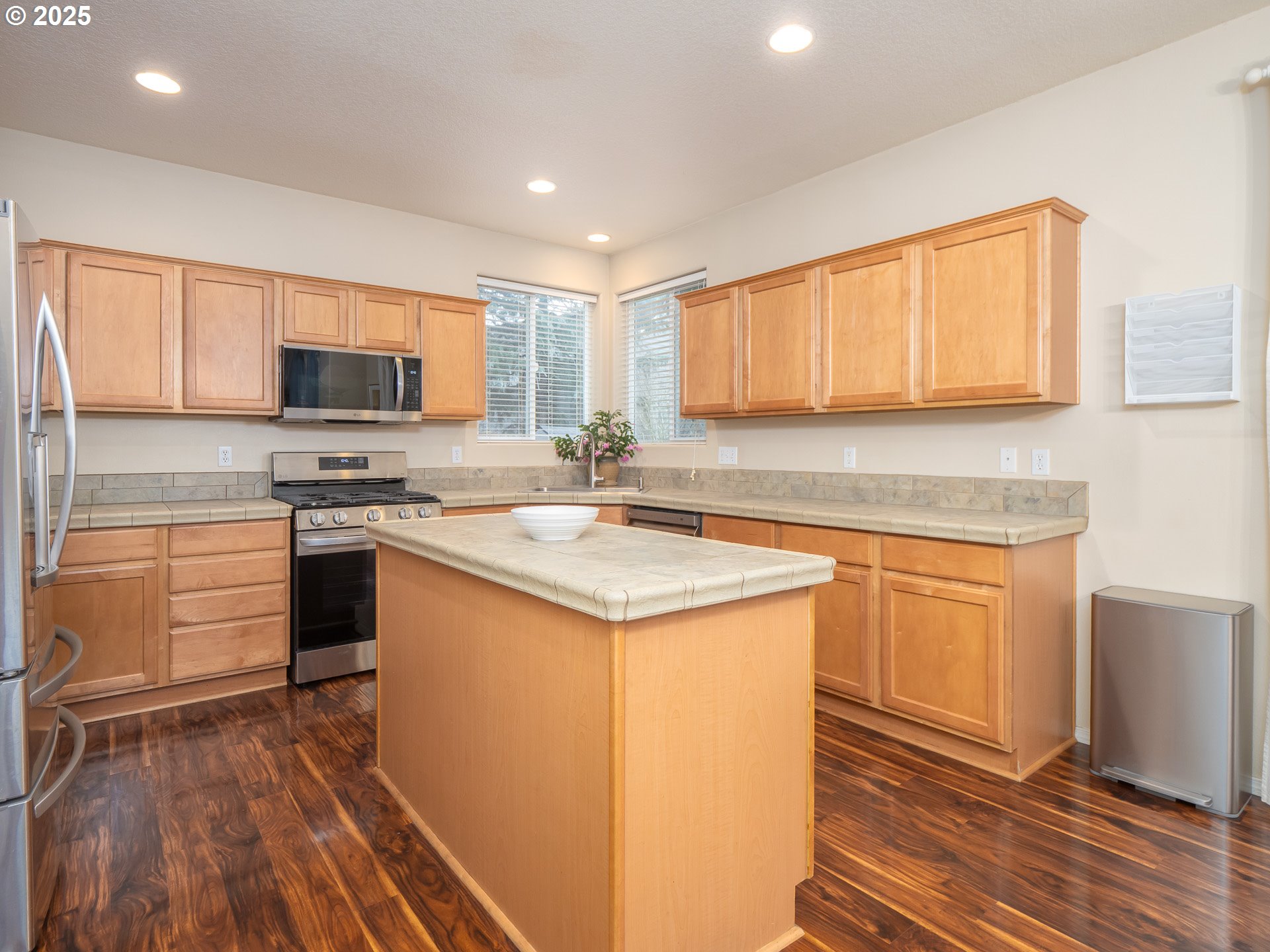 121 Burl Street Newberg, OR 97132 - Photo 14 of 48 a kitchen with granite countertop a stove top oven a sink dishwasher and a microwave oven with cabinets