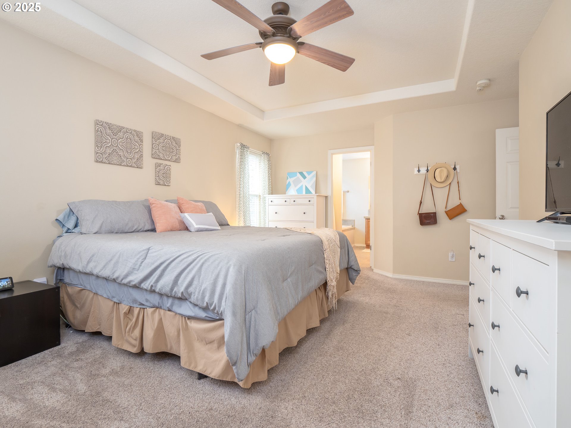 121 Burl Street Newberg, OR 97132 - Photo 22 of 48 a spacious bedroom with a bed and a chandelier