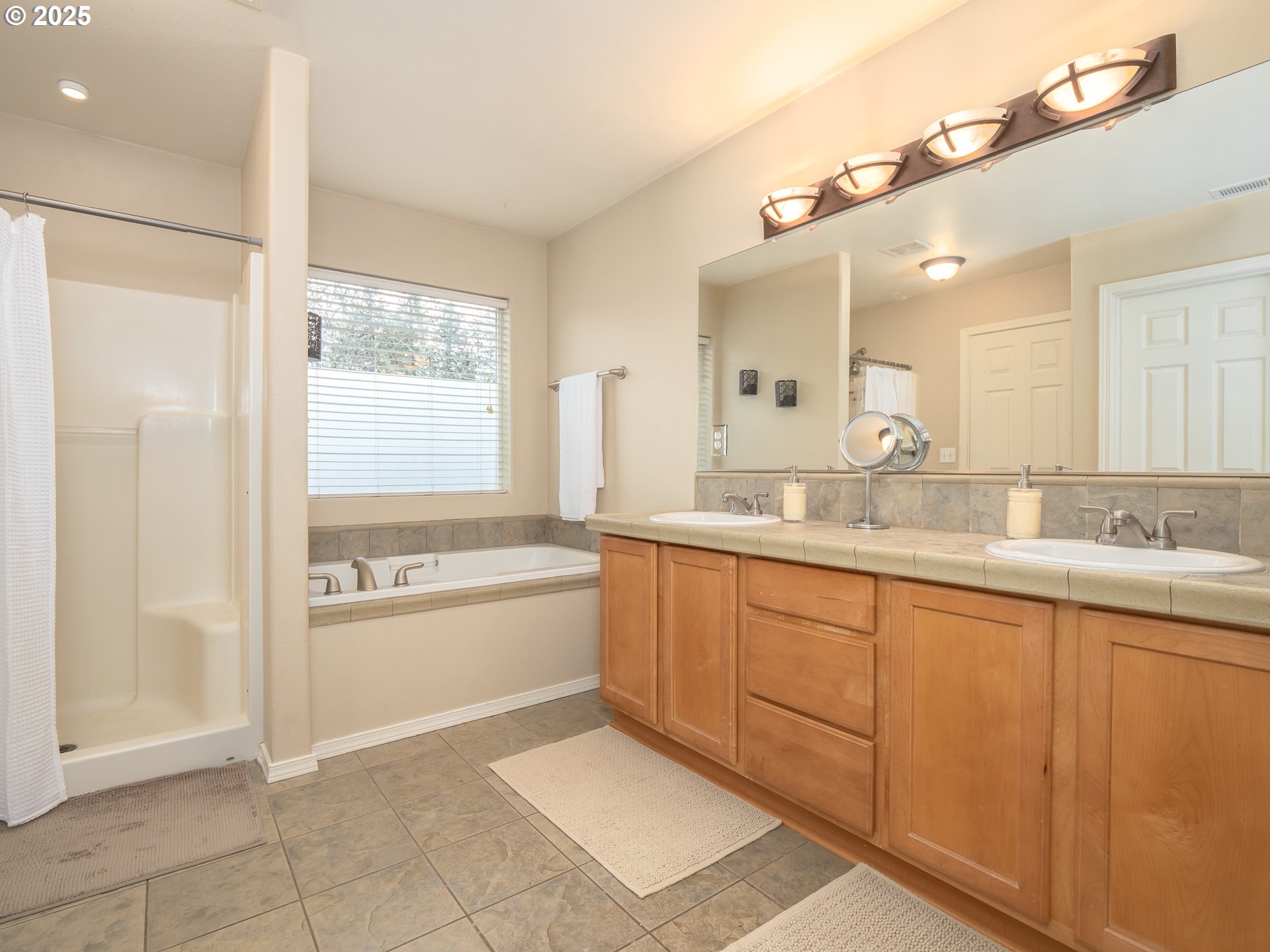 121 Burl Street Newberg, OR 97132 - Photo 23 of 48 a bathroom with a granite countertop sink mirror and a bathtub