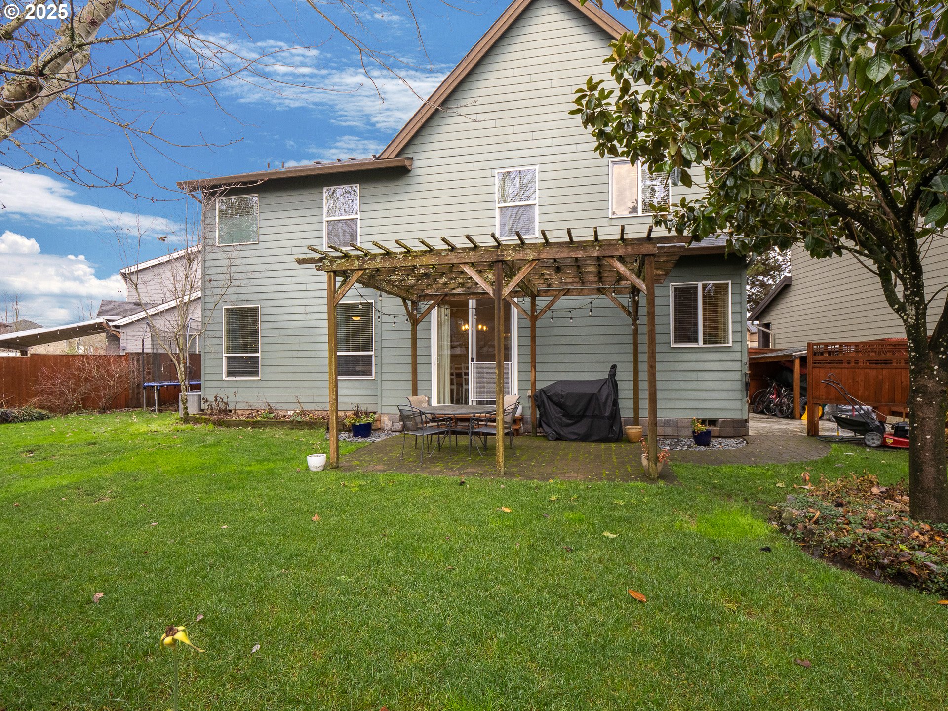 121 Burl Street Newberg, OR 97132 - Photo 31 of 48 a front view of a house with a garden and deck