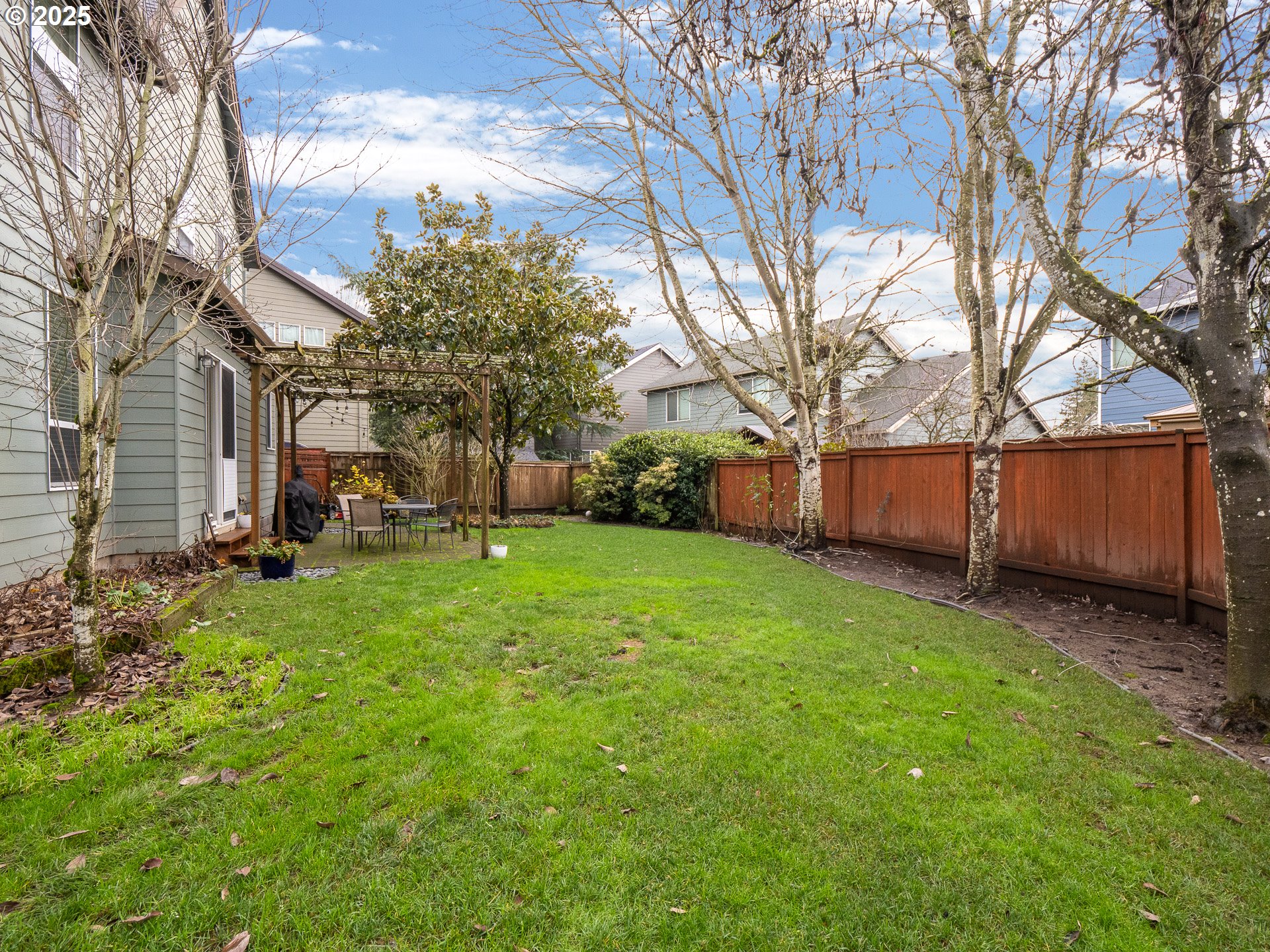 121 Burl Street Newberg, OR 97132 - Photo 36 of 48 a view of a backyard with large trees