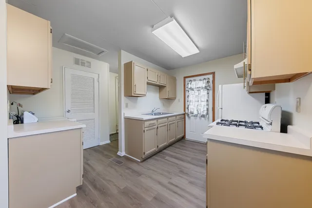 a kitchen with a sink stove and refrigerator