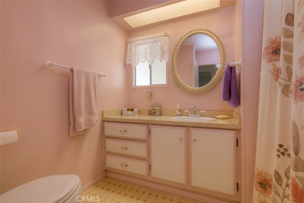 1901 Dayton Road, Unit 133 Chico, CA 95928 - Photo 24 of 36 a bathroom with a granite countertop toilet sink and mirror