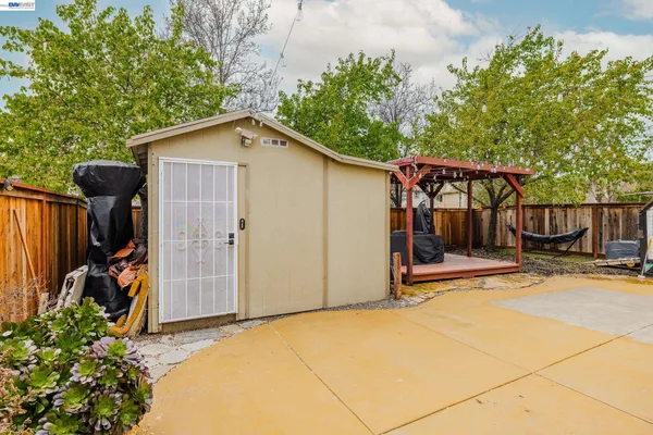a backyard of a house with table and chairs