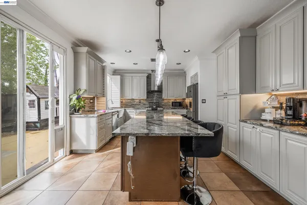 a kitchen with stainless steel appliances granite countertop a sink and cabinets