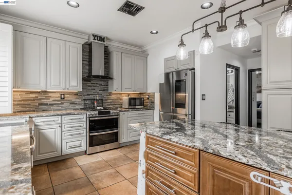 a kitchen with stainless steel appliances granite countertop a sink counter space cabinets and a window