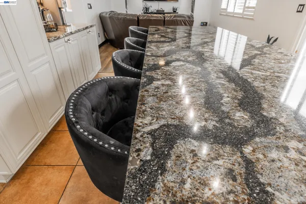 a bathroom with a granite countertop sink mirror vanity and toilet