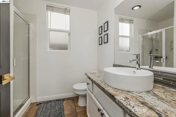 a view of a hallway with wooden floor and stairs