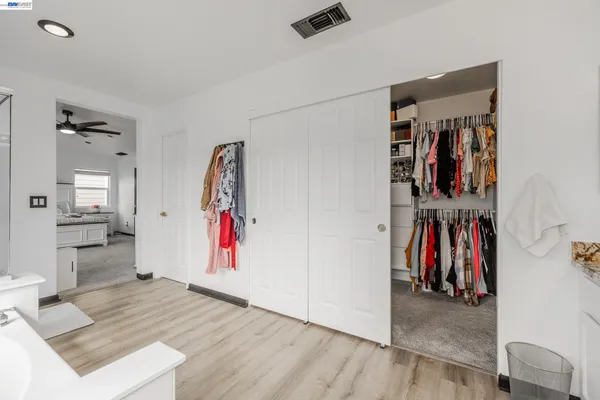 a view of a hallway with closet and furniture