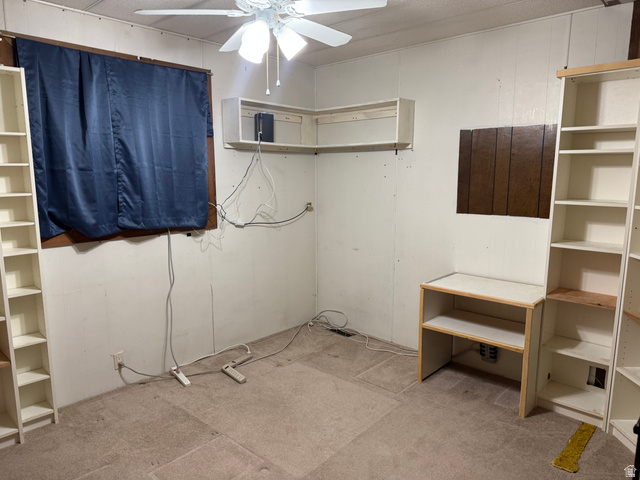 210 South State Street Moroni, UT 84646 - Photo 8 of 23 Interior space featuring wall-to-wall carpeting, a ceiling fan, and built-in shelving units