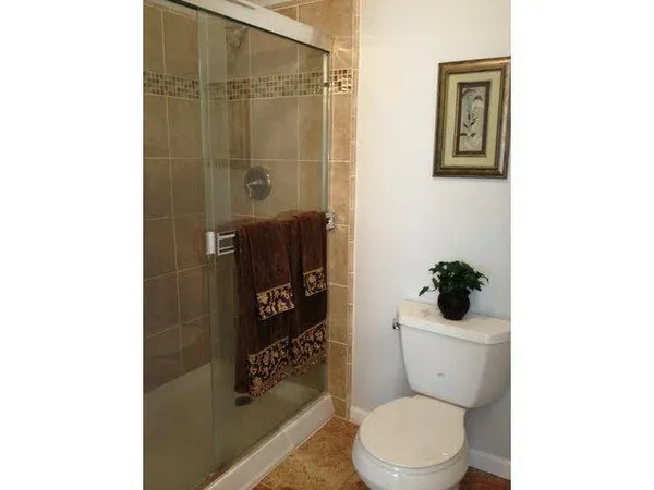 a white toilet sitting next to a bathroom sink